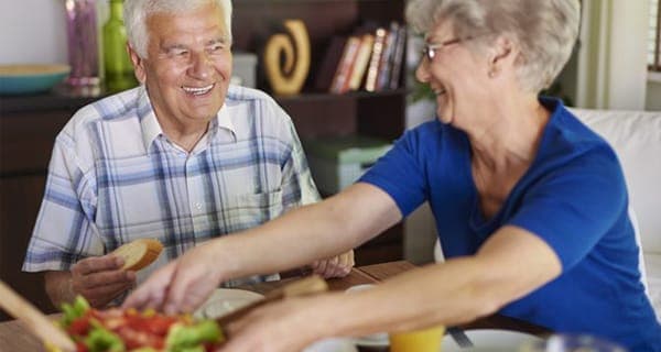 elderly couple enjoying dinner and conversation